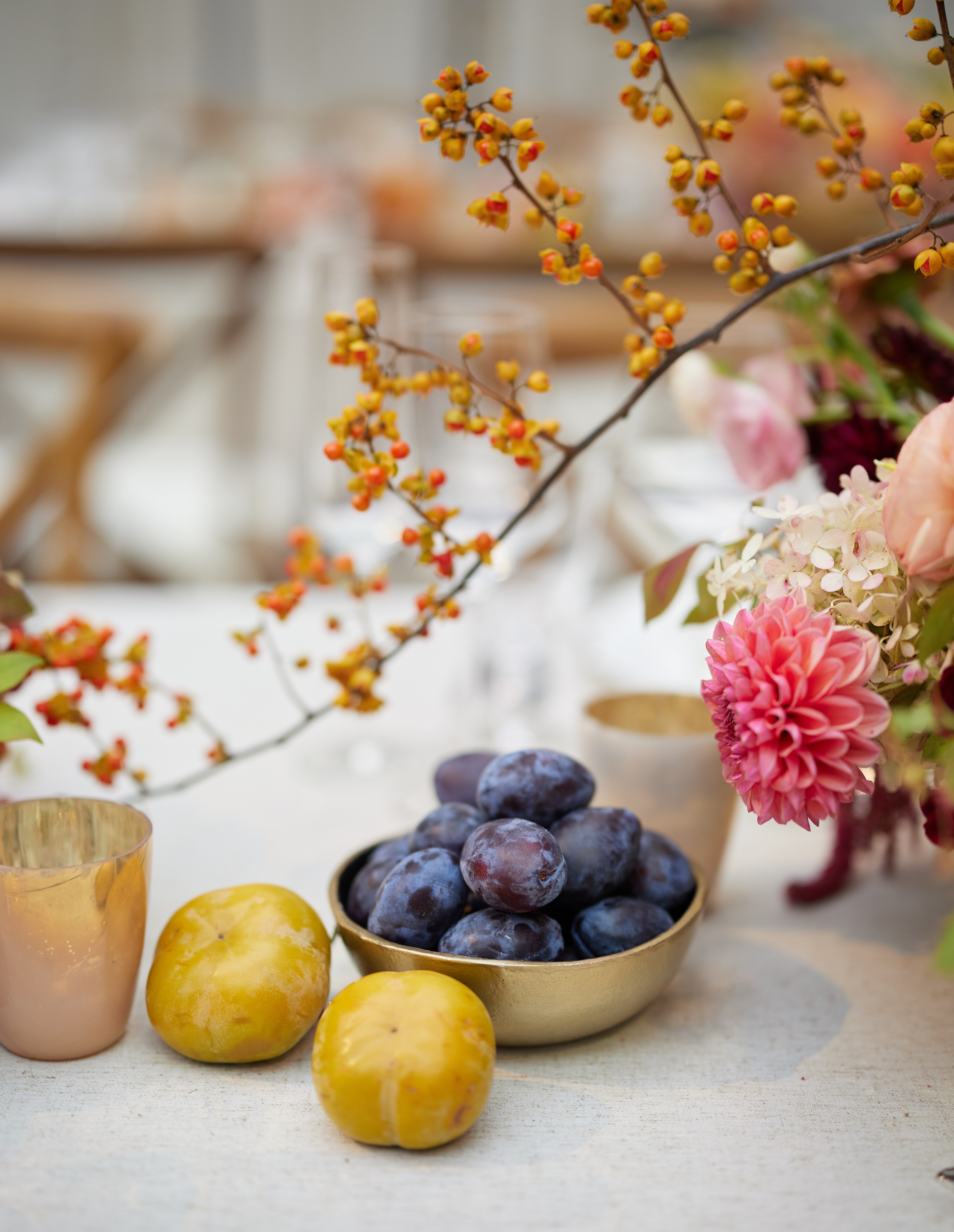 Grapes and floral arrangement on a table.